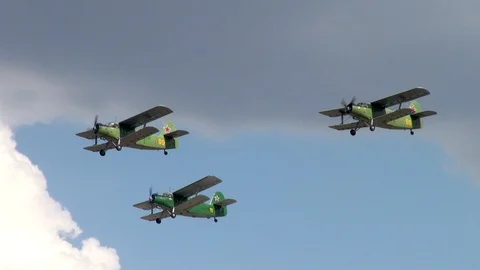 Three Soviet multi-purpose aircraft An-2 (NATO: Colt) perform group flight. Stock Footage 120804075