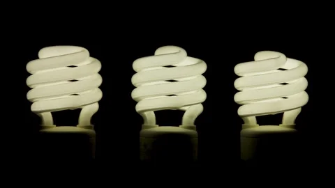 Three spiral light bulbs switch on and off sequentially Video stock 329666930
