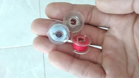 Three spool in hand Foto stock