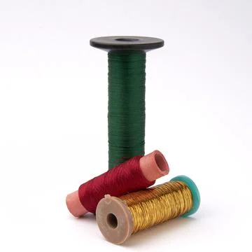 Three spools of colored thread on a white background Stock Photos