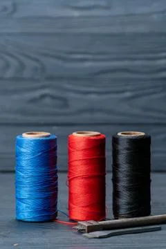 Three spools of thread black red and blue color tools for creating leather Stock Photos