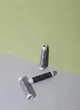 Three spools of thread on colorful background Foto stock