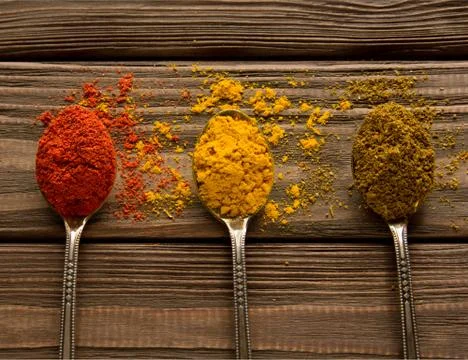 Three spoons with various spices. Close-up. Top view. Stock Photos
