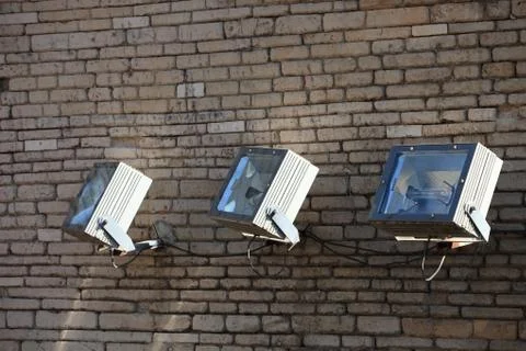 Three spotlights on a brick wall Stock Photos