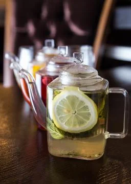 Three square teapots with different fruit tastes of tea Stock Photos