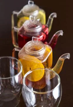 Three square teapots with different fruit tastes of tea Stock Photos