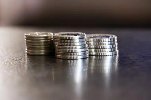 Three stack of coins on dark background Stock Photos
