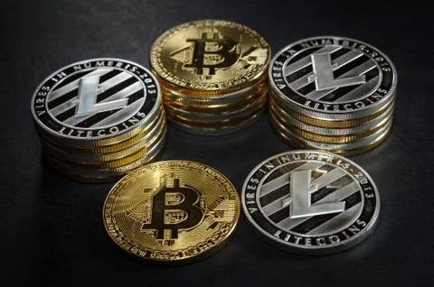 Three stack of cryptocurrency coins with single bitcoin and litecoin Stock-Fotos