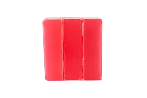 Three stacked red block soaps against plain white background. Stock Photos