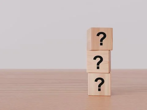 Three stacked wooden cubes featuring question mark symbols placed on a flat.. Stock Photos