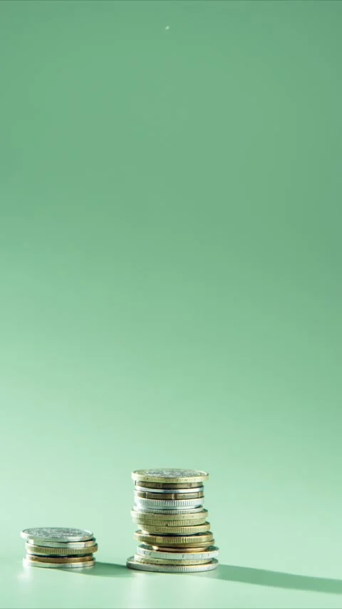 Three stacks towers of different coins appearing on green background arranging Stock Footage 232368635
