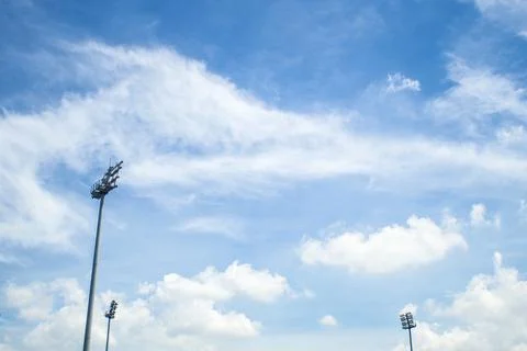 Three stadium light with blue sky in the football stadium. Stock Photos