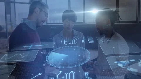 Three staff leaning over office table gesturing, blue flare forming holo UI for Stock Footage 333004725