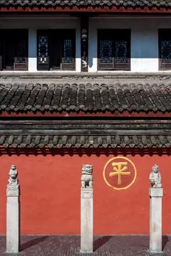 Three statues and red wall in wenshu monastery Фото