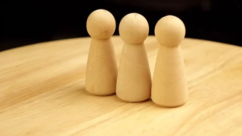 Three statuettes rotate 360 degrees on a wooden platform Stock Footage 119540343