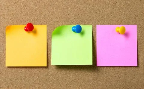 Three sticky notes attached to cork board Stock Photos