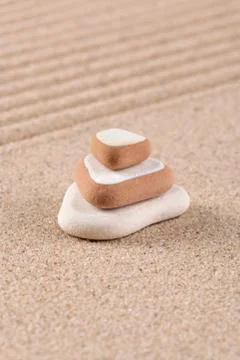 Three stone stack on raked sand. Stock Photos