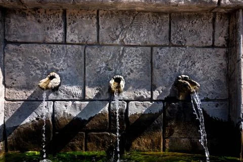 Three stone taps from which water flows Stock Photos