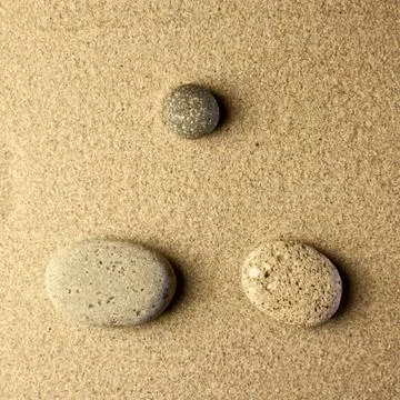 Three stones in the sand Stock Photos