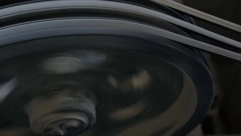 Three-strand pulley with belts rotates from powered electrical engine Stock Footage