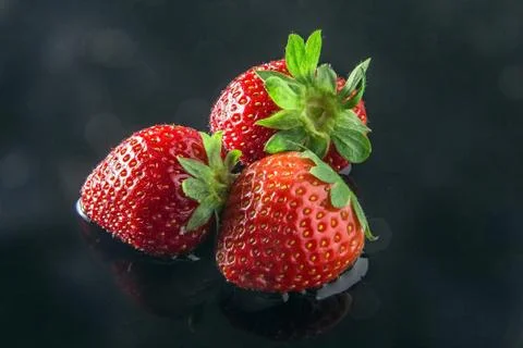Three strawberries Stock Photos