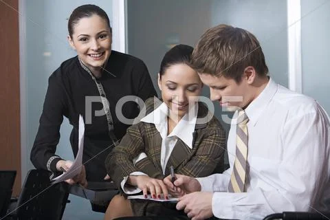 Three students are looking through their recordings Stock Photos