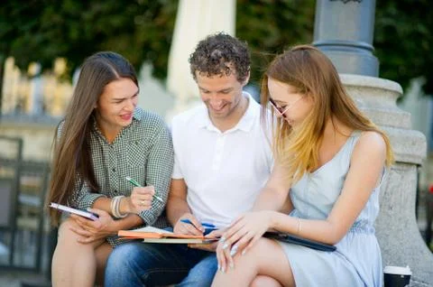 Three students are preparing for exams. Stock Photos