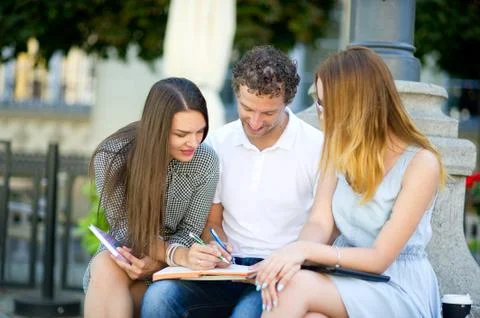 Three students are preparing for exams. Stock Photos