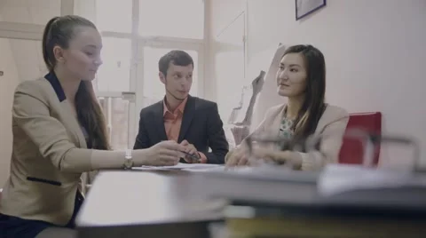 Three students communicate young businessman sitting in the office Stock Footage 63116037