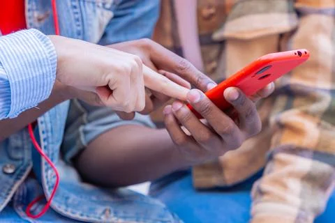 Three students having fun with mobile phones creating content on social media. Stock Photos