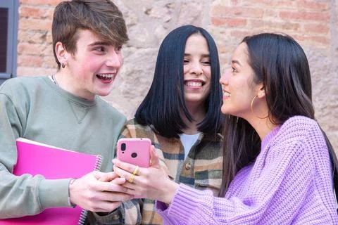 Three students having fun with mobile phones creating content on social media. Stock-Fotos