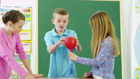 Three students having a scientific experiment Video stock 80131638