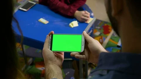 Three students participating at workshop in class room and watching phone w.. Video stock 74355800