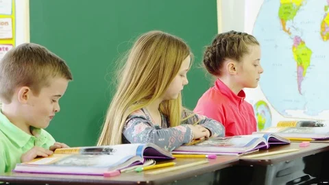 Three students reading textbooks in classroom Video stock 80131461