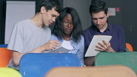 Three students sitting in seminar room and doing homework Stock Footage 105191289
