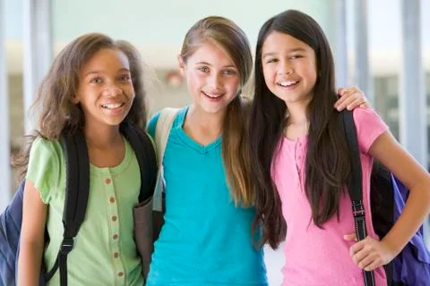 Three students standing outside school together smiling (selective focus) Stock Photos