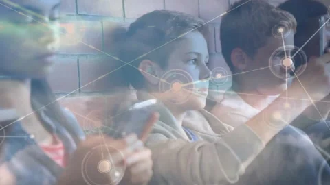 Three students tapping devices in school, causing glowing node mesh linking Video stock 332282055