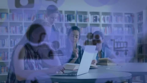 Three students typing on laptop and consulting notes for study, creating Stock Footage 329910950