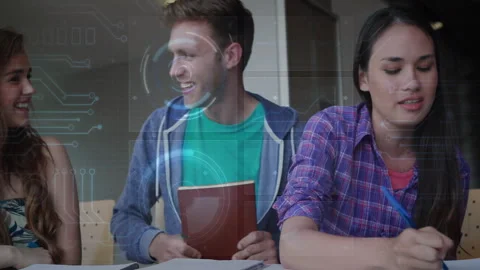 Three students writing notes at table, interacting with circuit graphics showing Stock Footage 307463639