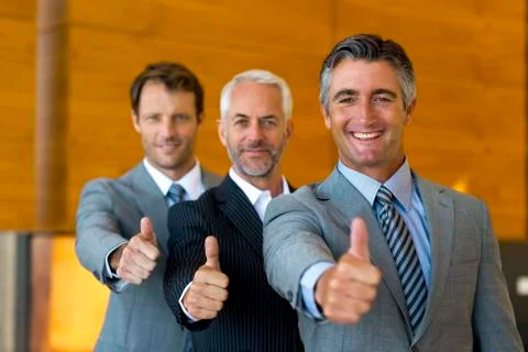 Three successful executives in a line. Stock Photos
