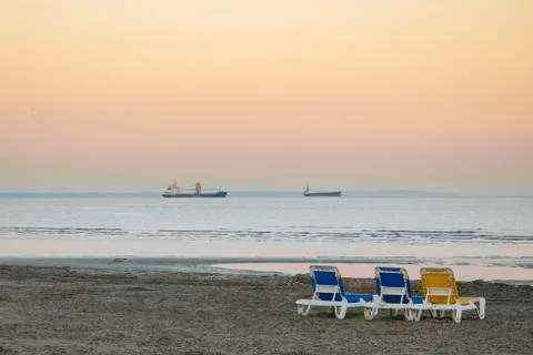 Three sunbeds on beach Stock Photos