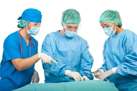 Three surgeons in operation room Stock Photos