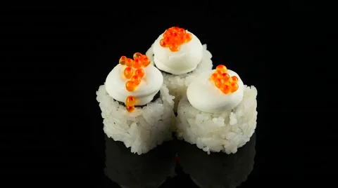 Three sushi with caviar on black background rotating (loop) Stock Footage 55638488