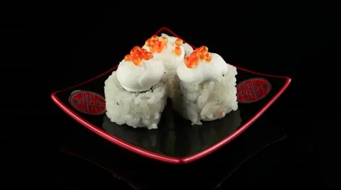 Three sushi with caviar on black plate rotating (loop) Stock Footage 55638250