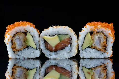 Three sushi rolls. Sushi with reflection. Traditional japanese food Stock-Fotos