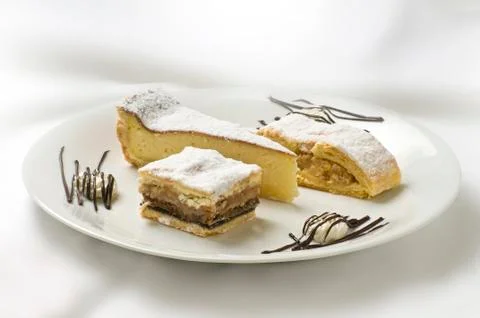 Three sweets on a plate Stock Photos