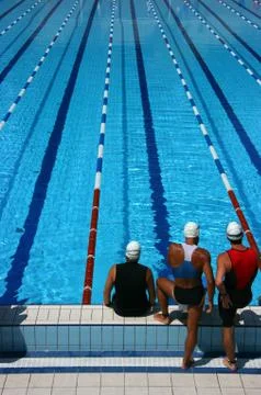 Three swimmers ready to dive Stock-Fotos