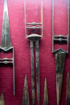 Three swords are displayed on a red background. in Chennai Fotos Stock