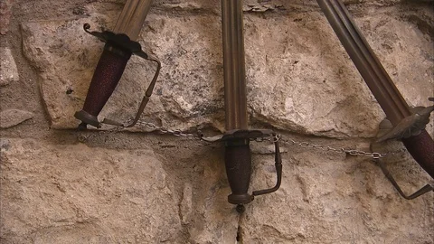 Three swords hanging on a castle wall Stock Footage 86261136