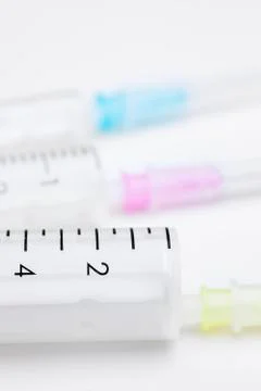 Three syringes in different sizes and colors on white background used as medi 写真素材